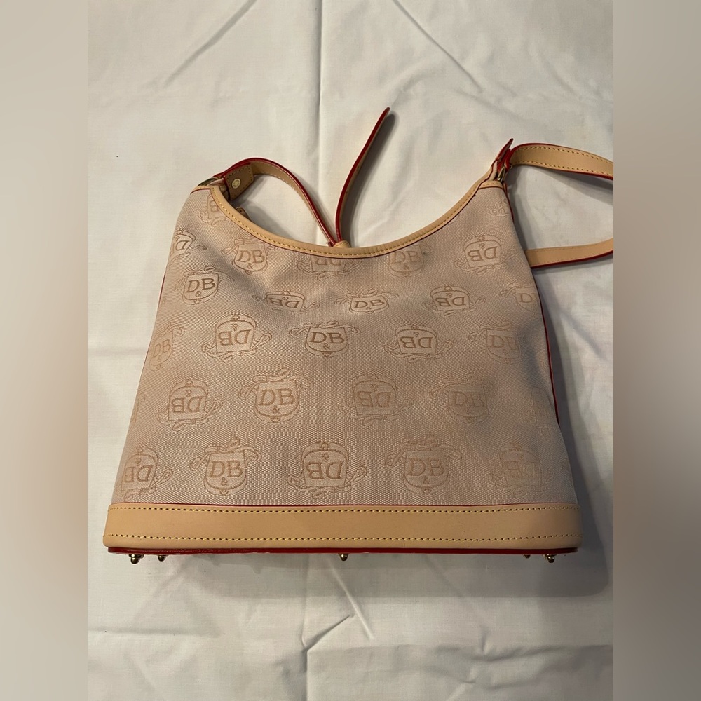 Dooney & Bourke shoulder bag in tan material with tan trim.